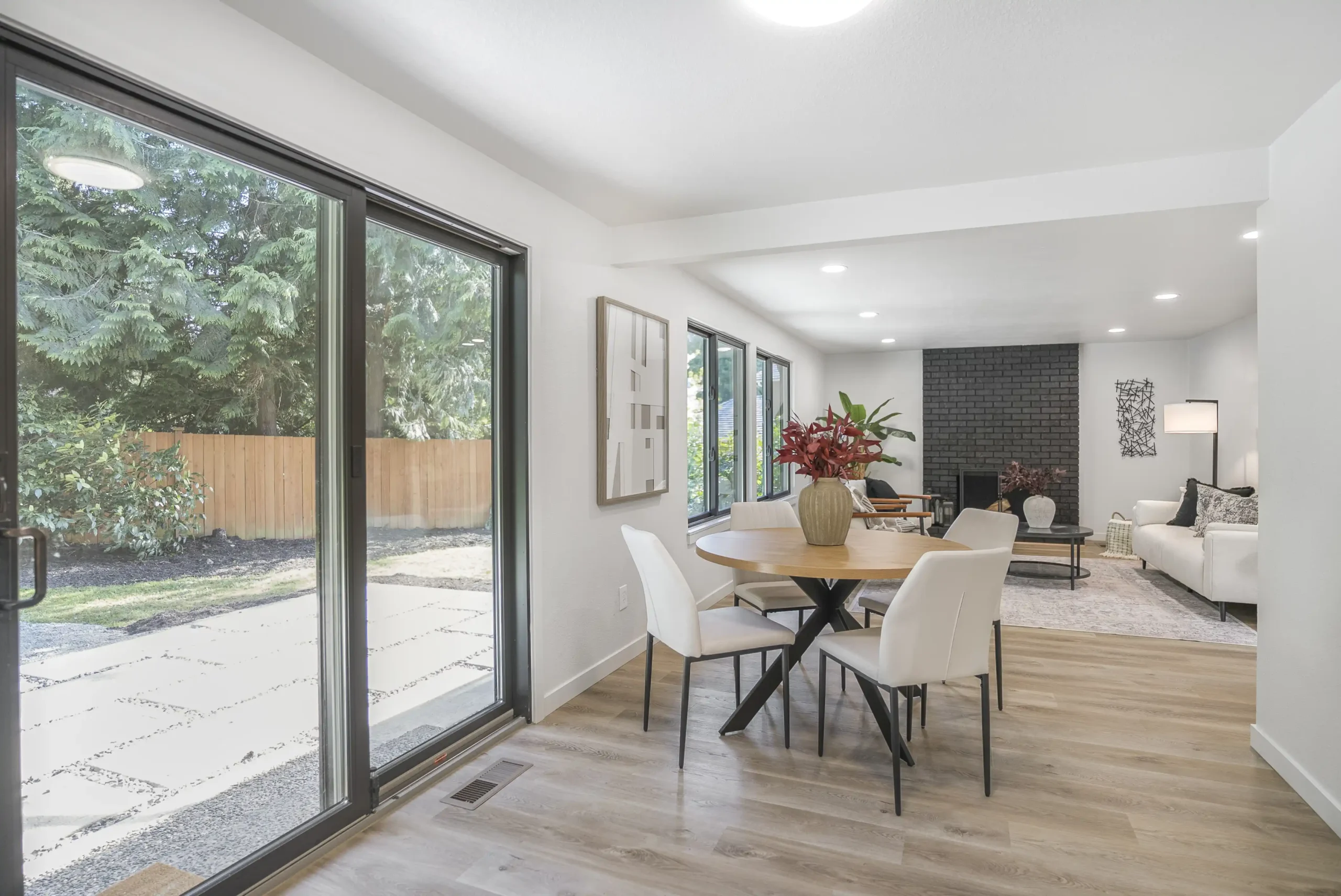 Bright Seattle kitchen renovation before listing, featuring light oak cabinets, quartz counters, matte black fixtures, and rain visible through large windows