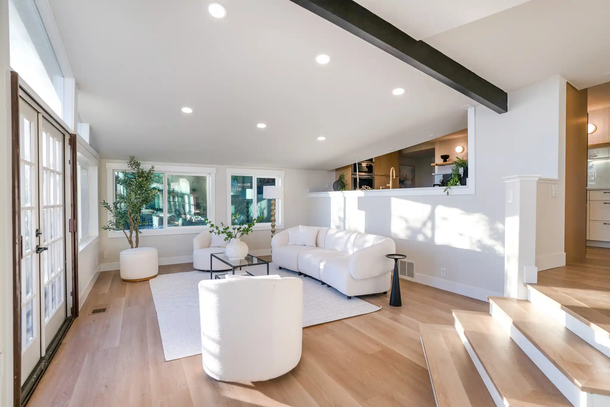 bright Seattle kitchen update with shaker cabinets, brass hardware, quartz counters, subway tile backsplash, and rain-speckled windows