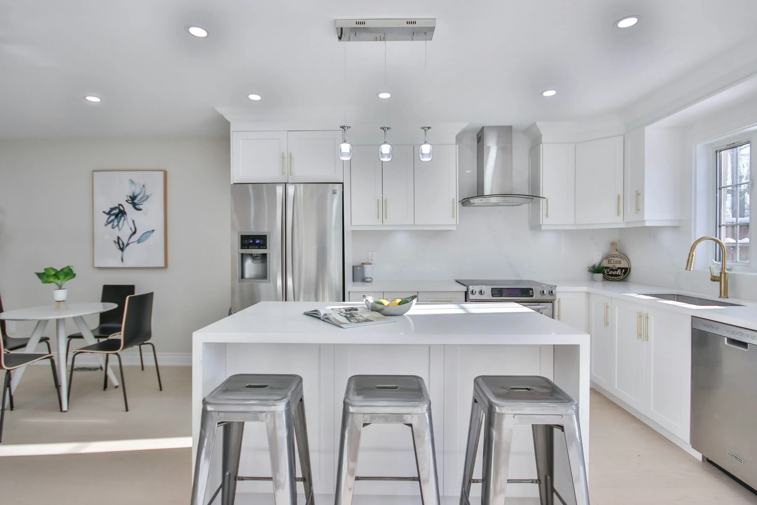 freshly renovated Seattle kitchen in a staged home with navy cabinetry, brass hardware, waterfall island, and soft natural light for a pre-listing marketing shoot