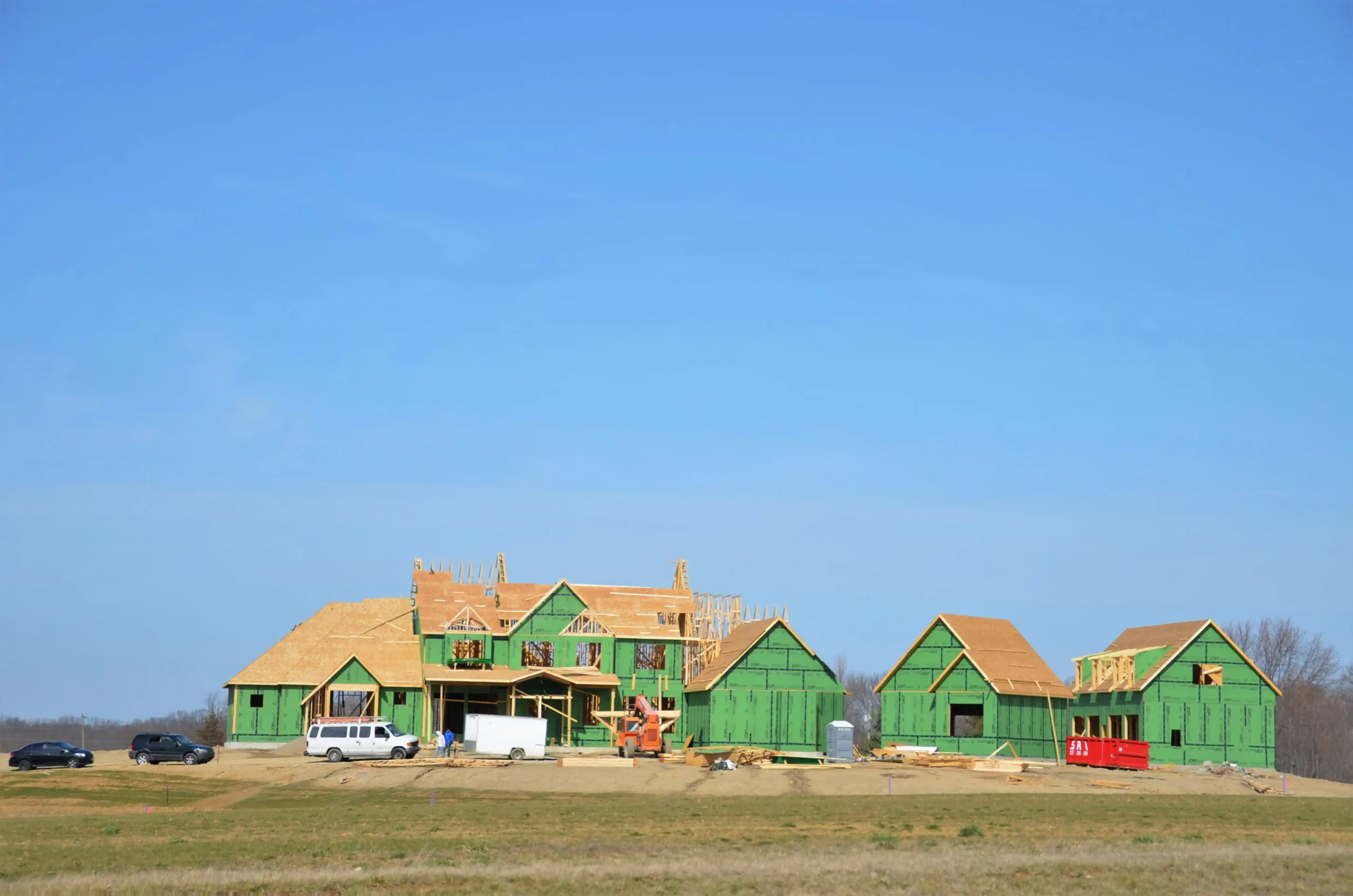 partially completed custom home showing foundation, framing, roofing, and interior rough-ins in a split-view construction timeline illustration with labeled stages