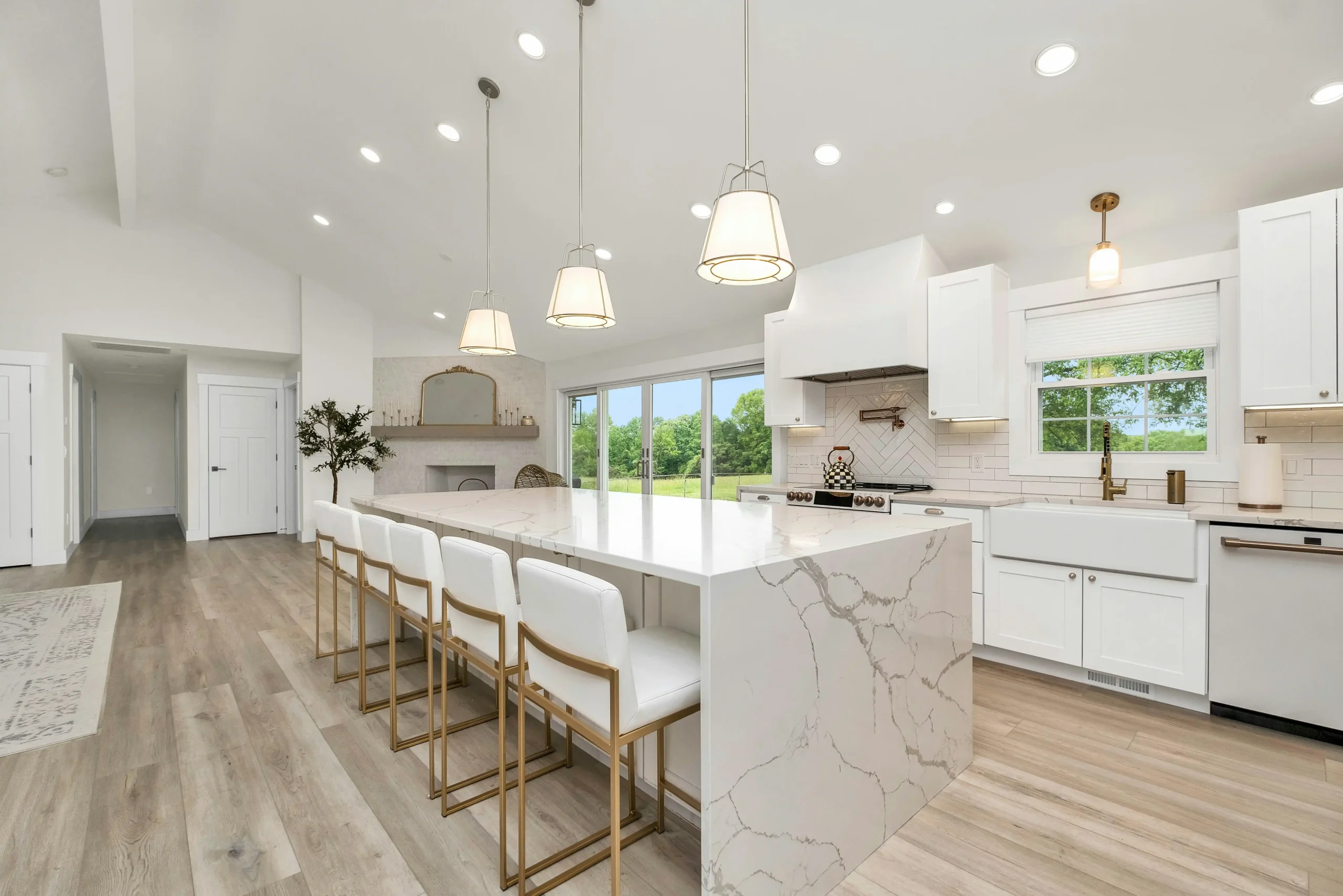 bright staged Seattle home interior showing updated kitchen, bathroom vanity materials, flooring samples, and contractor estimate sheets spread across a kitchen island
