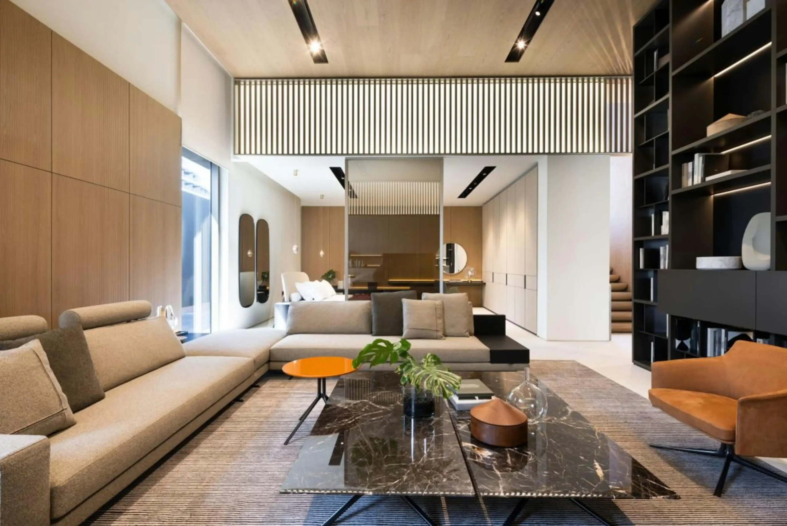 elegant open-concept living room renovation in a Pacific Northwest home, wide plank oak floors, black-framed windows, new recessed lighting, and a contractor presenting final pl...