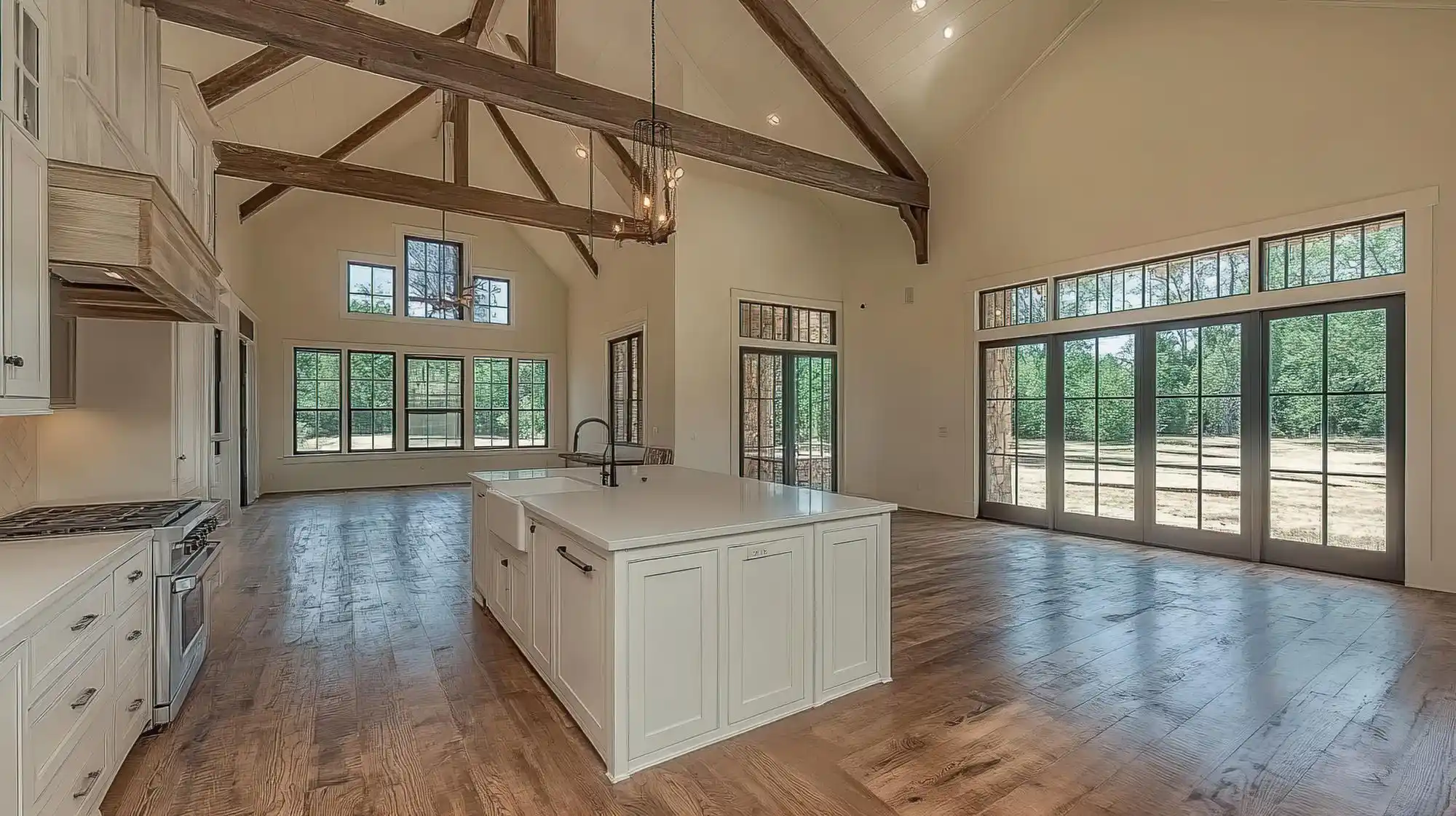 upscale Seattle home interior under construction with exposed framing, large black-framed windows, stacked hardwood flooring, and cabinetry samples on a worktable