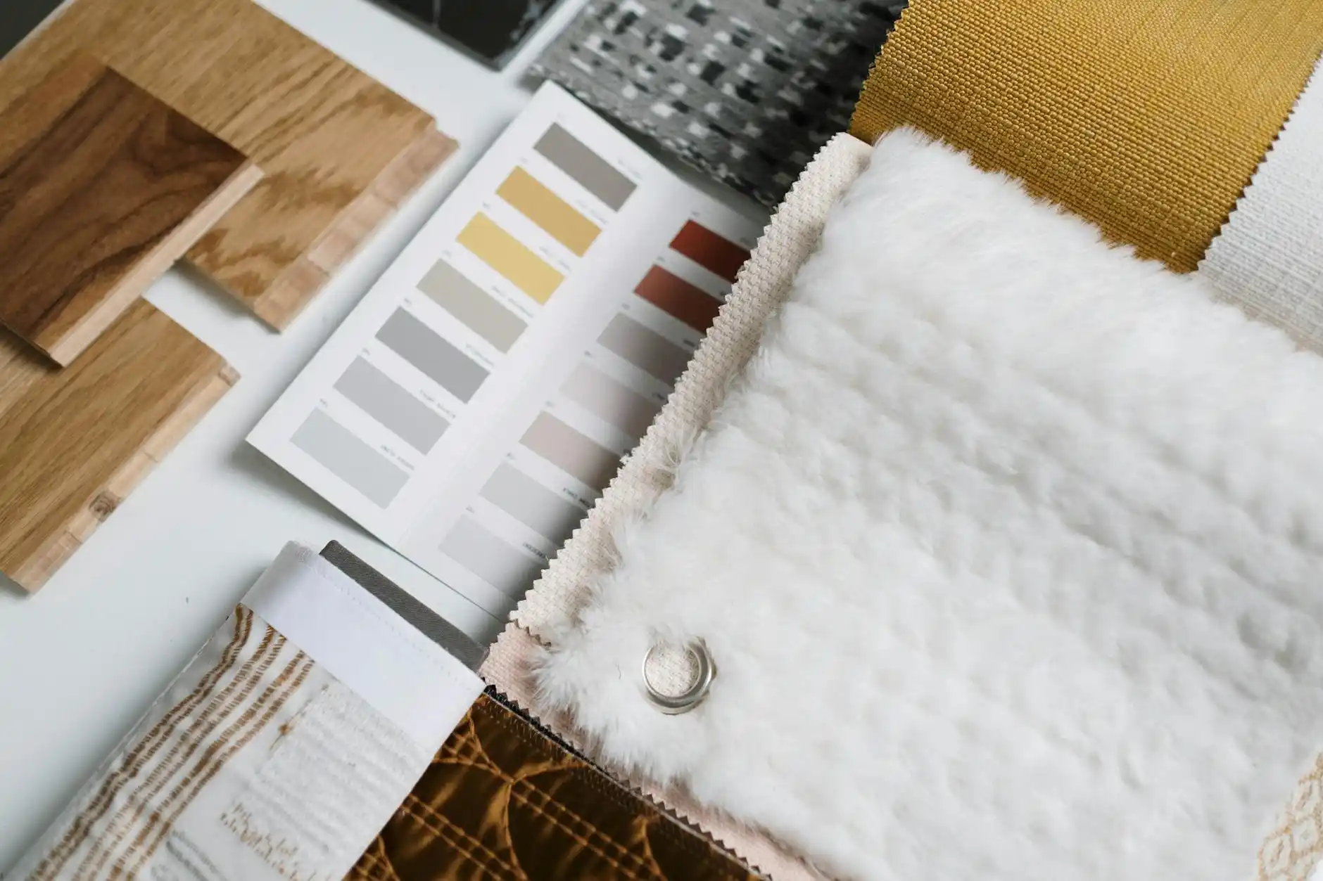 elegant custom home interior mood board with white oak flooring, matte black fixtures, quartz countertops, cabinet samples, tile swatches, and labeled budget notes