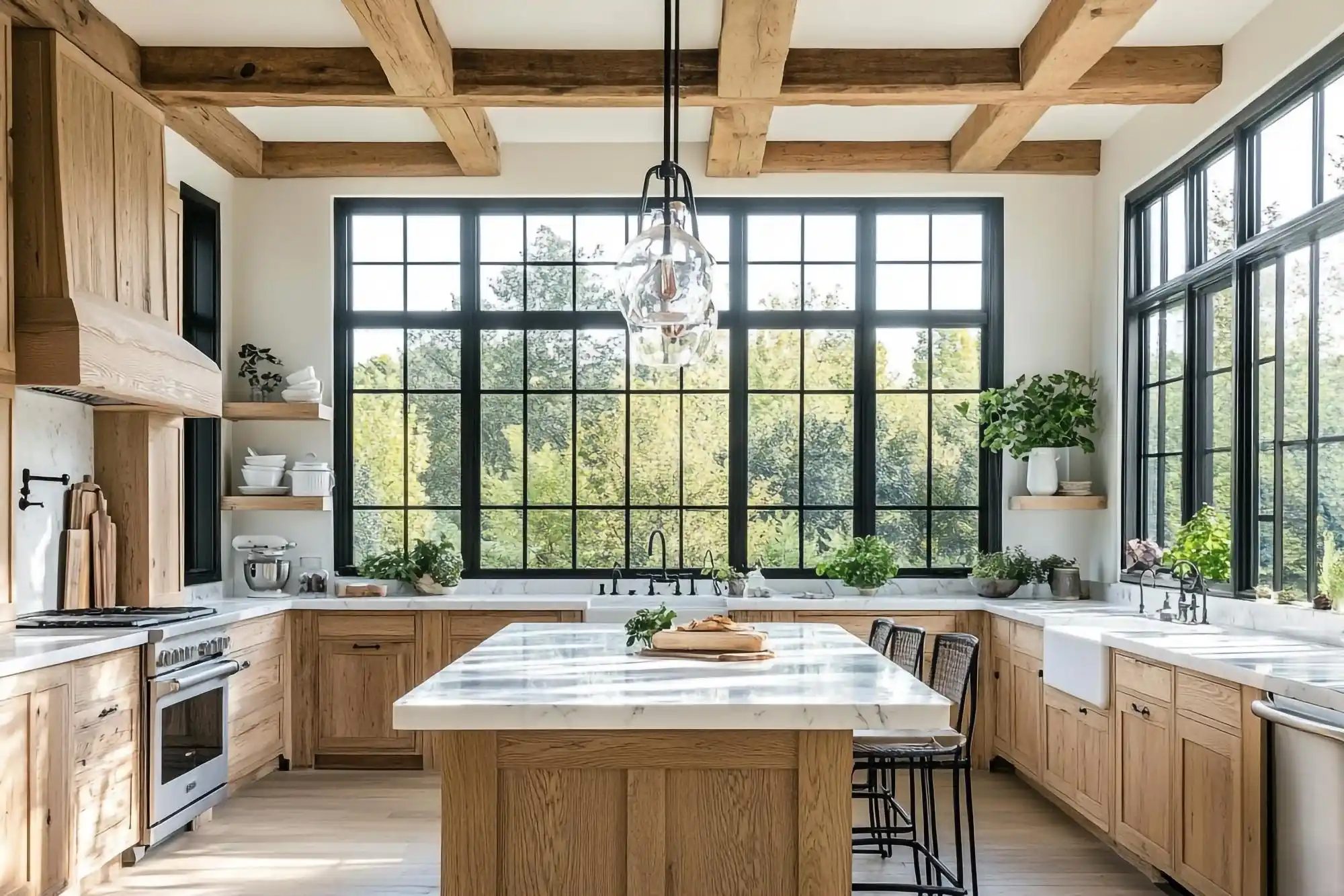 luxury kitchen remodel in progress with navy island base, unfinished oak flooring, gold pendant lights waiting for installation, and large windows overlooking a suburban backyard