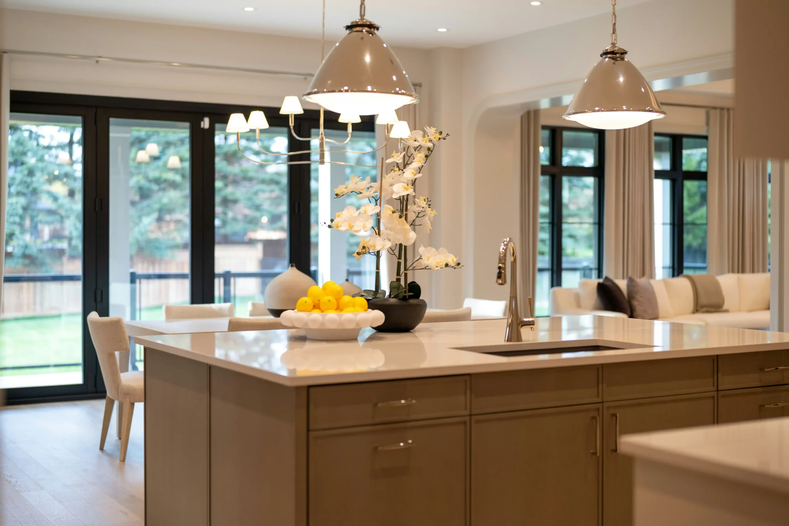 elegant nearly finished custom home interior with labeled finish boards, hardwood samples, lighting catalog, and contractor notes on a kitchen island