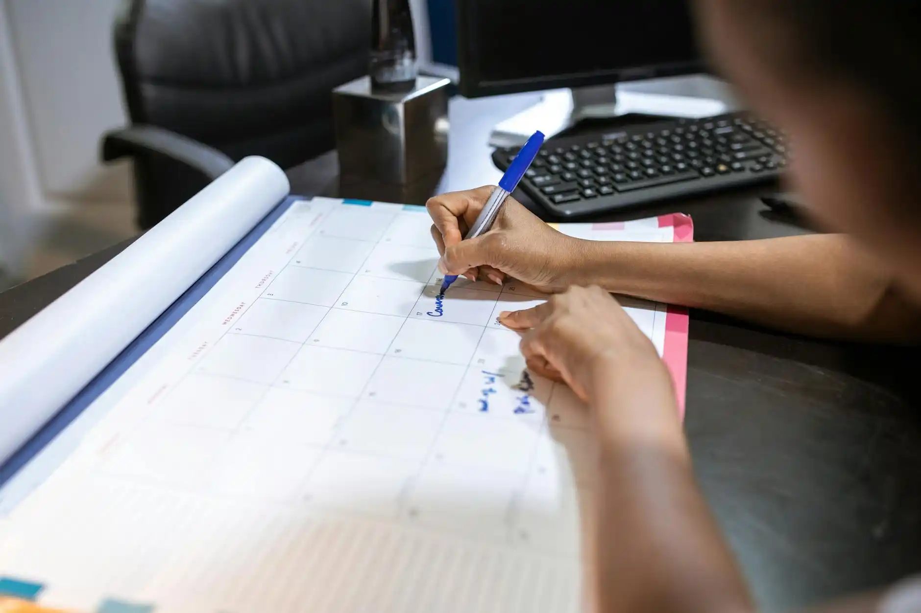 loan officer, homeowner, and contractor meeting in a modern office reviewing itemized renovation bids, escrow schedule, and calendar deadlines