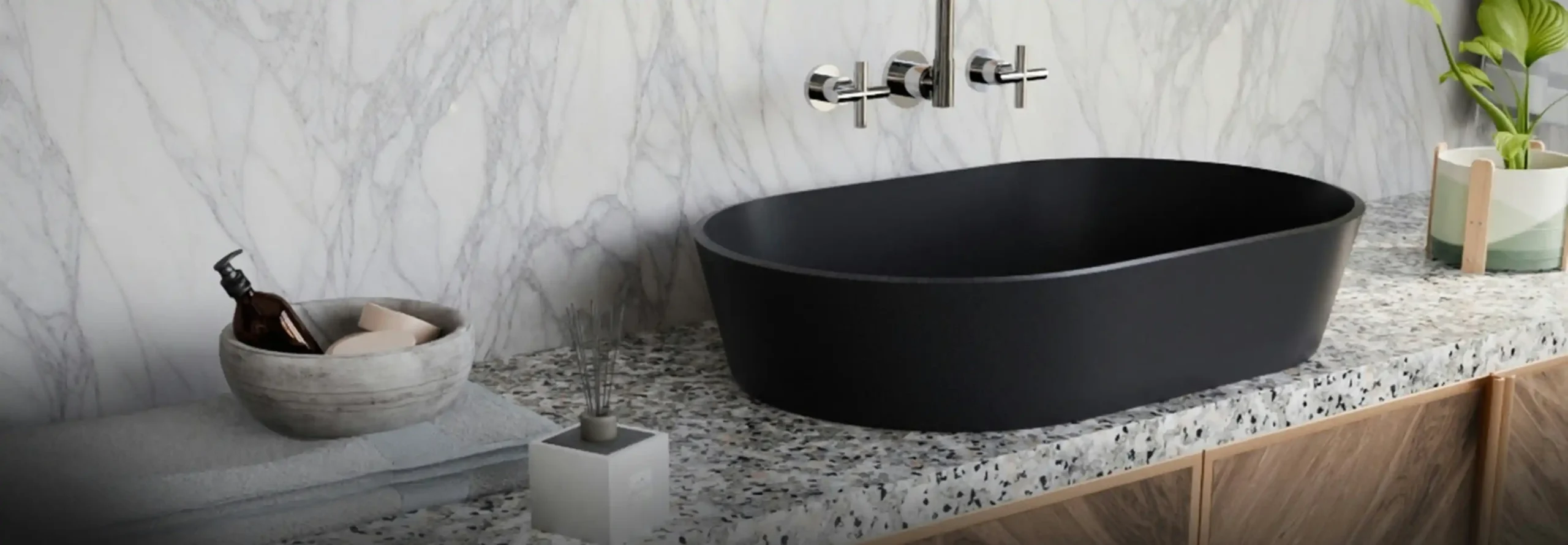 contractor installing large-format porcelain tile in a contemporary bathroom shower niche with leveling clips, waterproof membrane visible, matte black fixtures nearby
