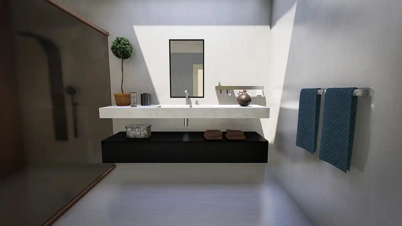 compact modern bathroom with floating oak vanity, frameless glass shower, large round mirror, soft brass fixtures, and light gray tile in a narrow urban home
