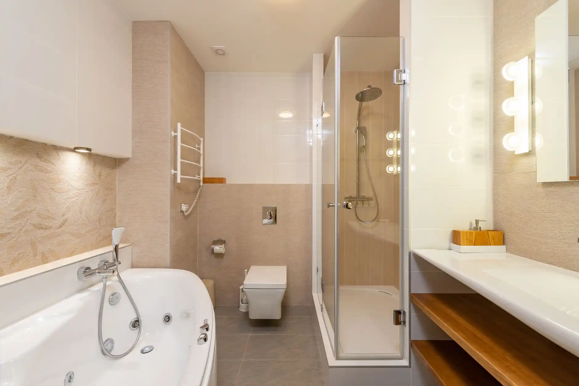 elegant renovated bathroom with walk-in shower, frameless glass, white oak vanity, matte black fixtures, and soft recessed lighting in a contemporary suburban home