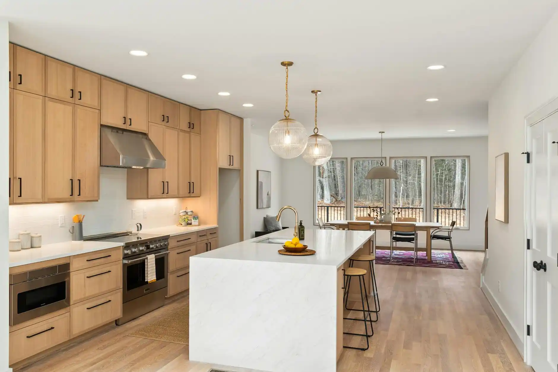 side-by-side comparison of budget kitchen refresh and luxury kitchen renovation, showing laminate counters versus waterfall marble island and custom cabinetry