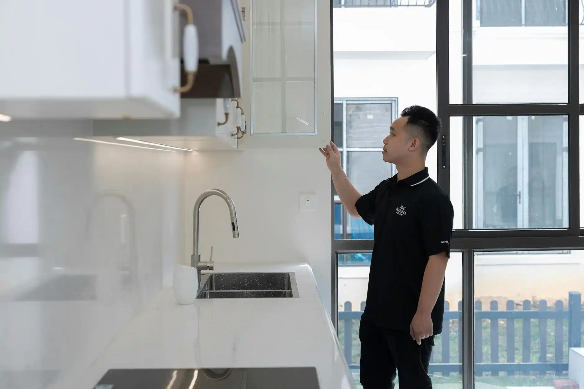 upscale residential project meeting with designer, contractor, and homeowners reviewing elevations, renovation timeline, and lender checklist in a sunlit modern kitchen