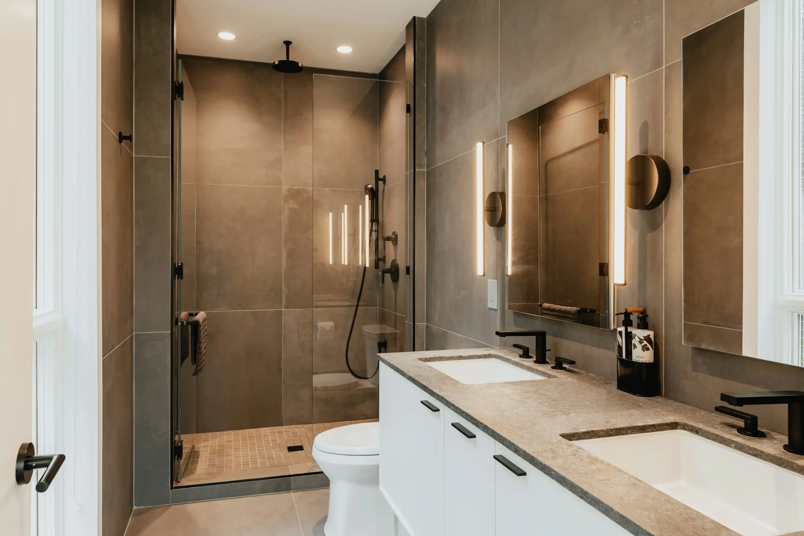 split-view residential renovation collage showing updated bathroom with frameless glass shower, contemporary kitchen with oak cabinetry, and exterior roof repair on a craftsman ...
