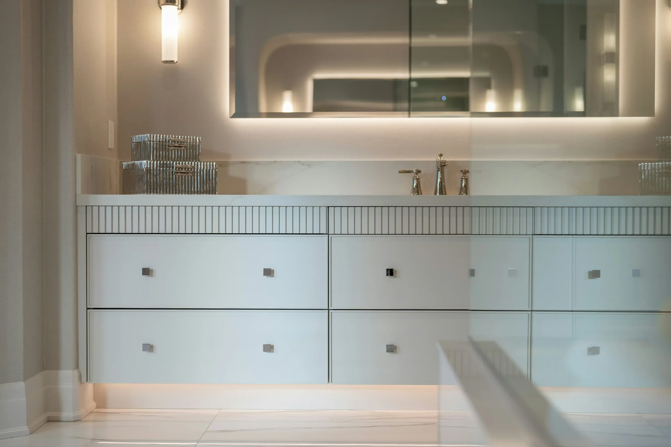 close-up cutaway of custom bathroom vanity cabinet showing plywood construction, soft-close drawer slides, pull-out organizer, and built-in electrical outlet drawer