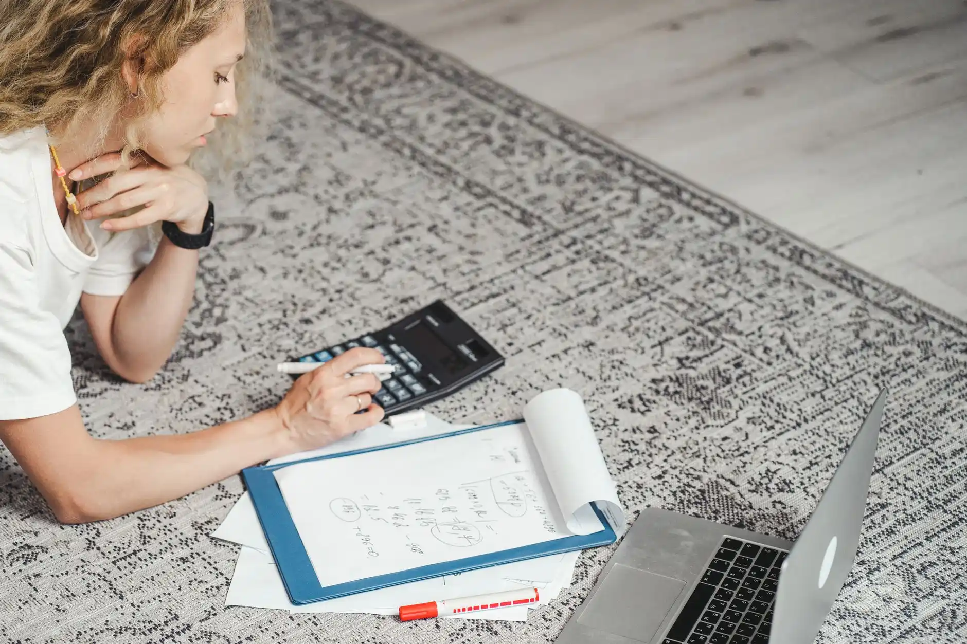 Three remodeling estimates spread side by side with highlighted scope differences, allowance amounts, exclusions, and a calculator, realistic overhead desk scene