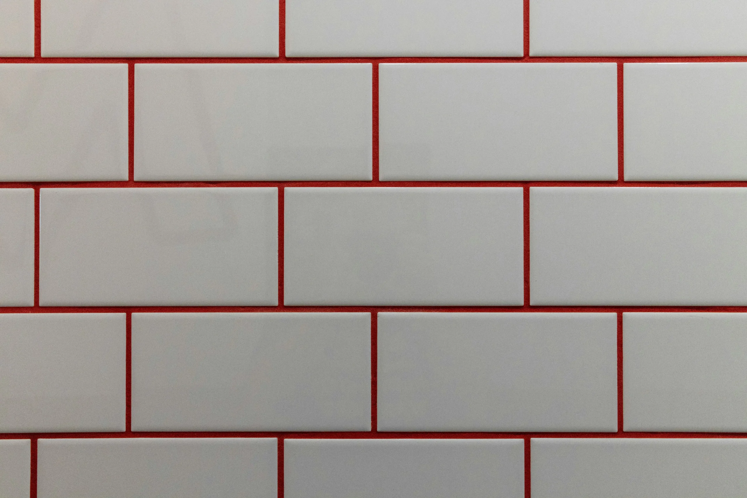 side-by-side bathroom remodel comparison showing the same white tile installed in stacked, herringbone, and basketweave patterns with different visual moods