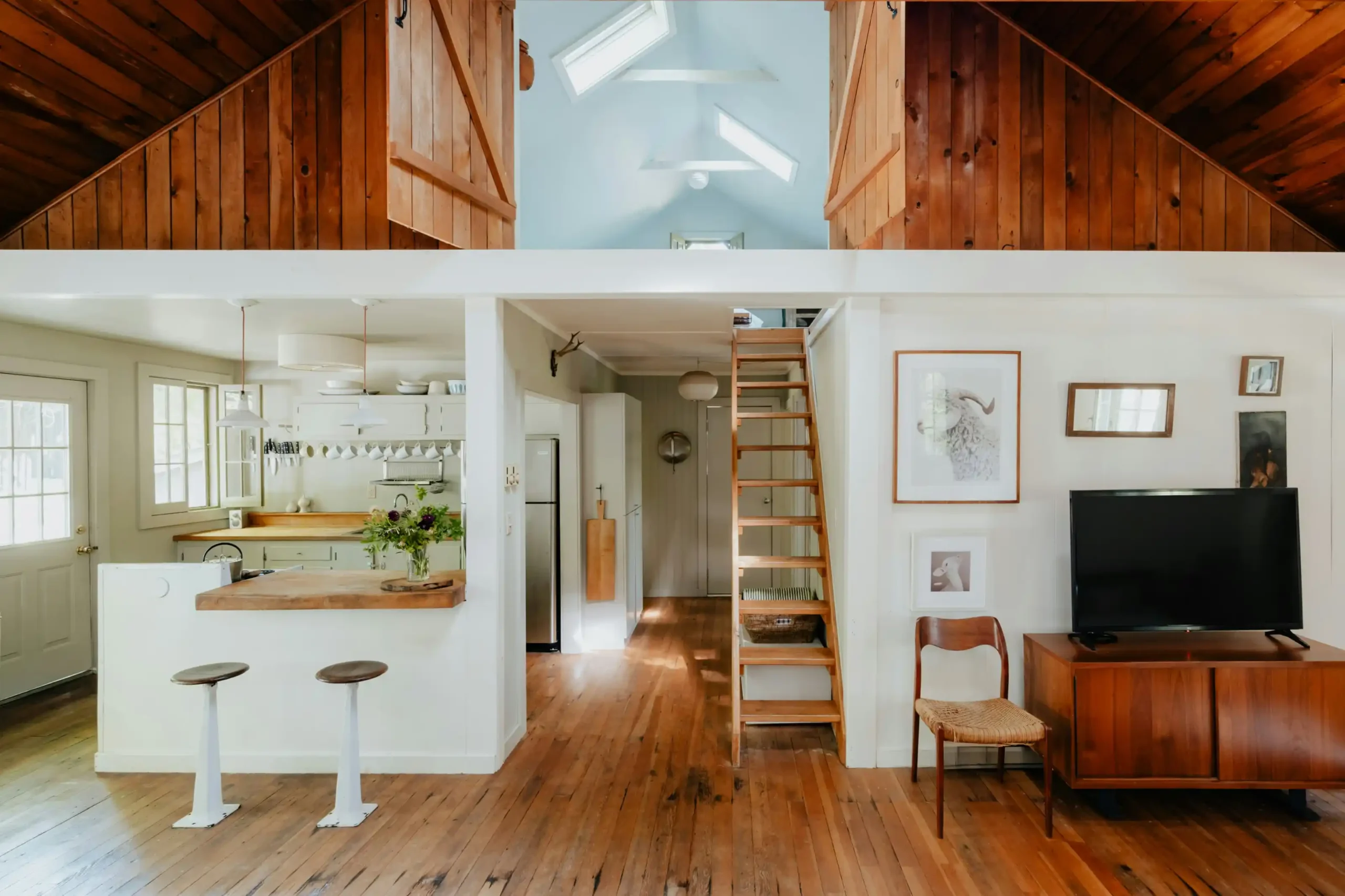 split-view interior showing remodeled kitchen opening to living area, nearby pantry and powder room, with clear walking paths highlighted