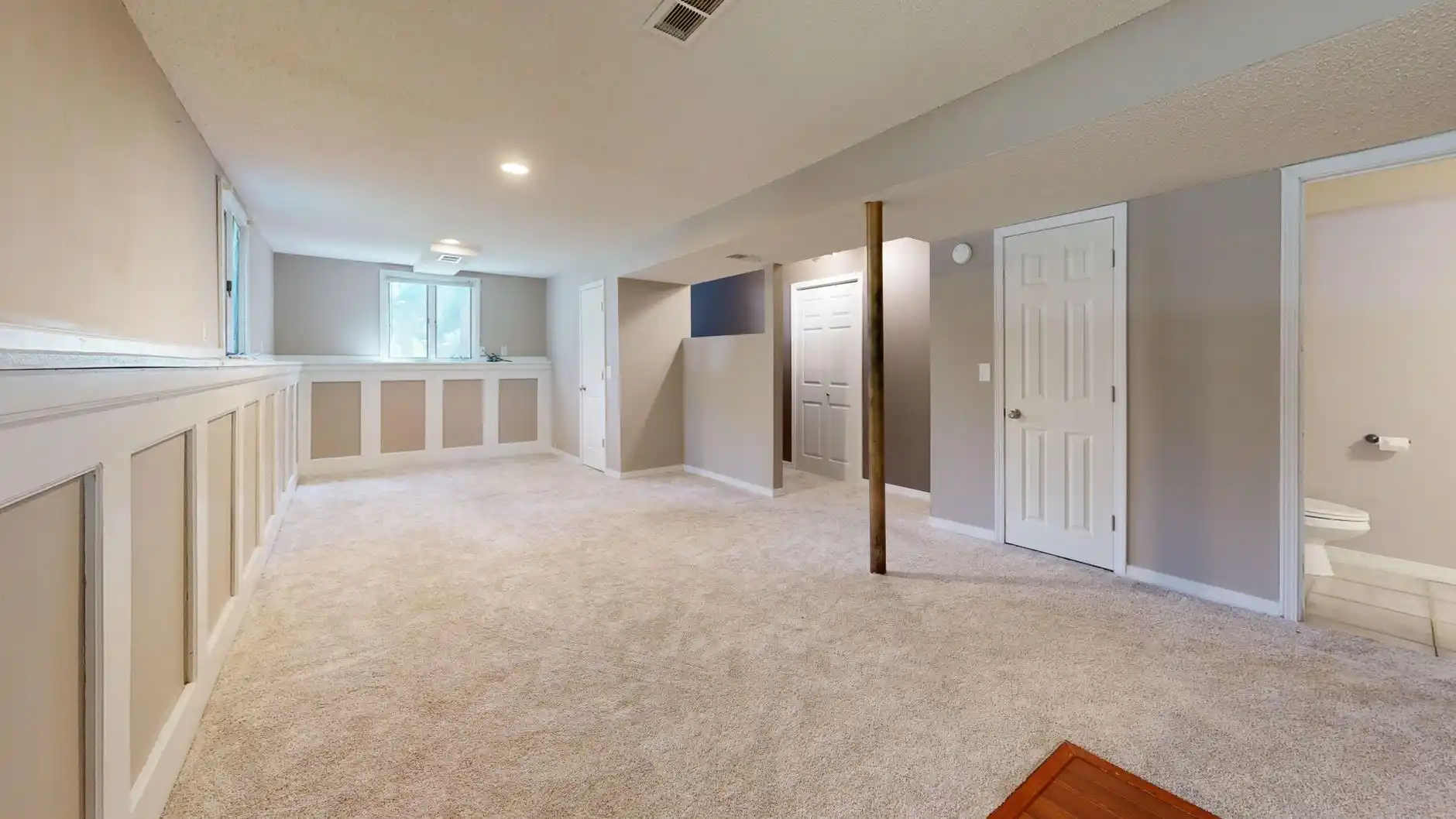 Editorial photograph illustrating "Start With Moisture, Not Flooring" in the context of basement remodel cost Seattle, natural daylight, realistic setting, no text or logos in f...