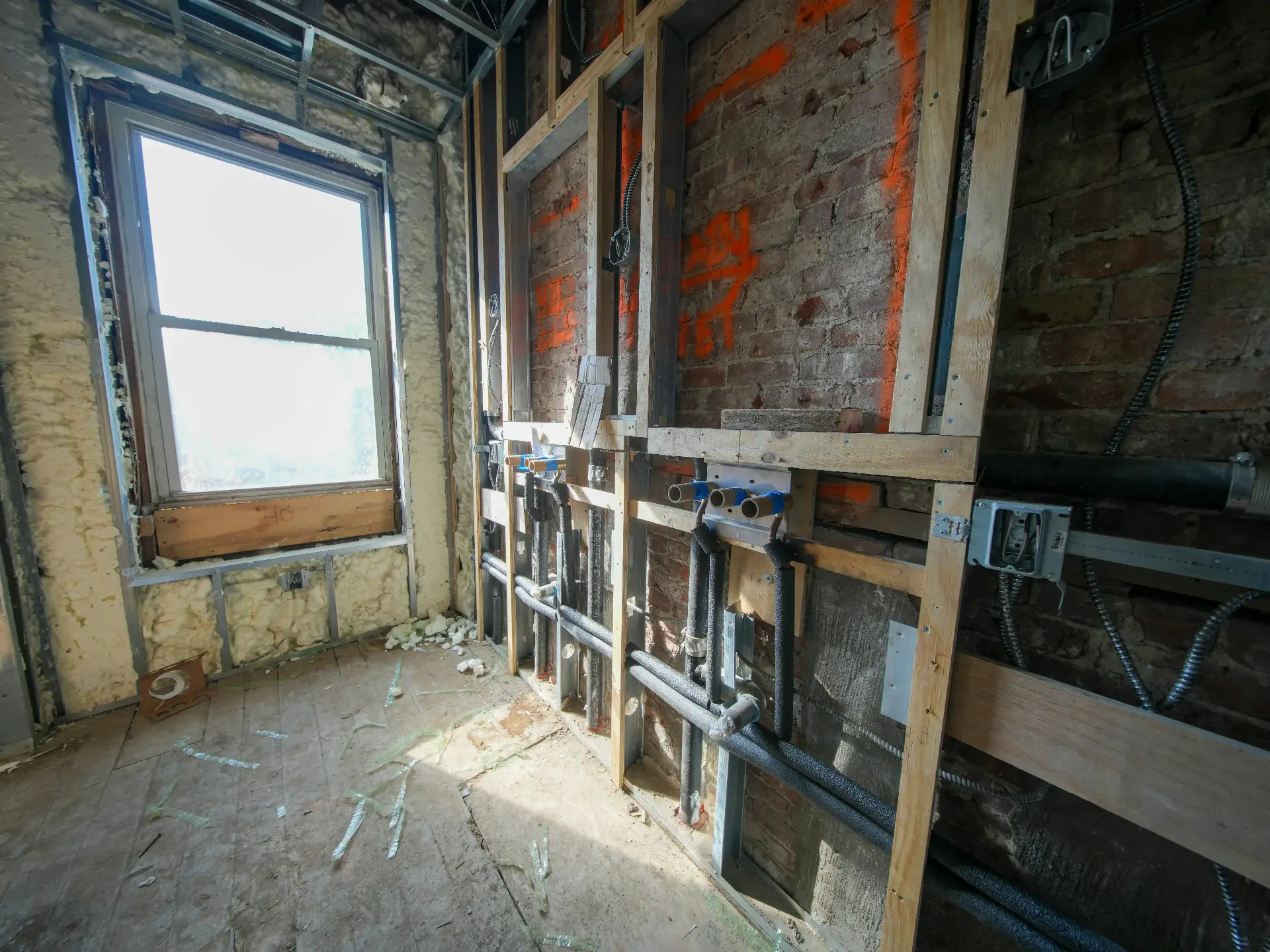 Editorial photograph illustrating "Old Electrical Systems and Layered Electrical Work" in the context of hidden problems in older Seattle homes, natural daylight, realistic sett...