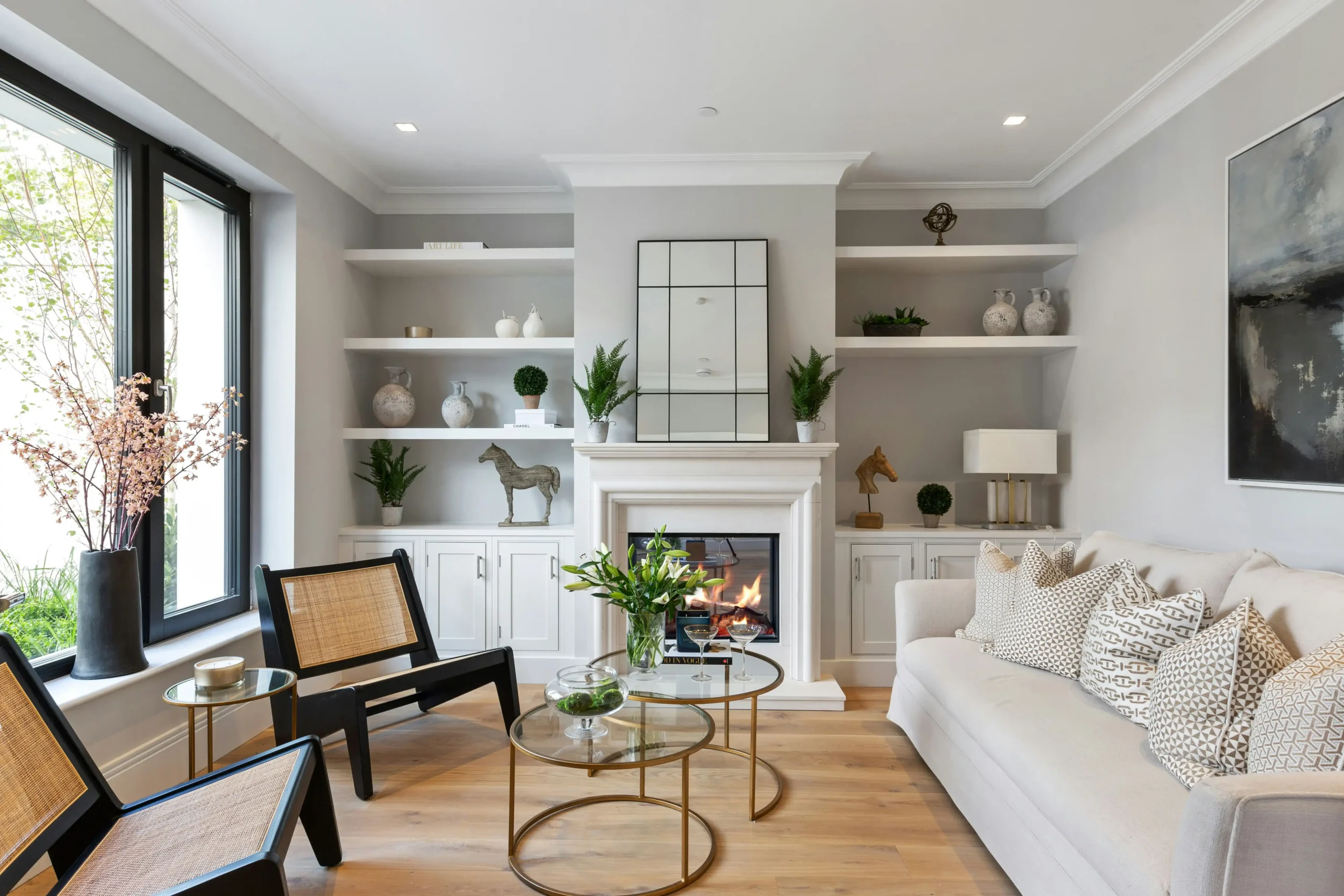 Bright professionally photographed Seattle Craftsman living room with warm neutral walls, restored fir flooring, consistent warm lighting, minimal staging, large windows, and su...