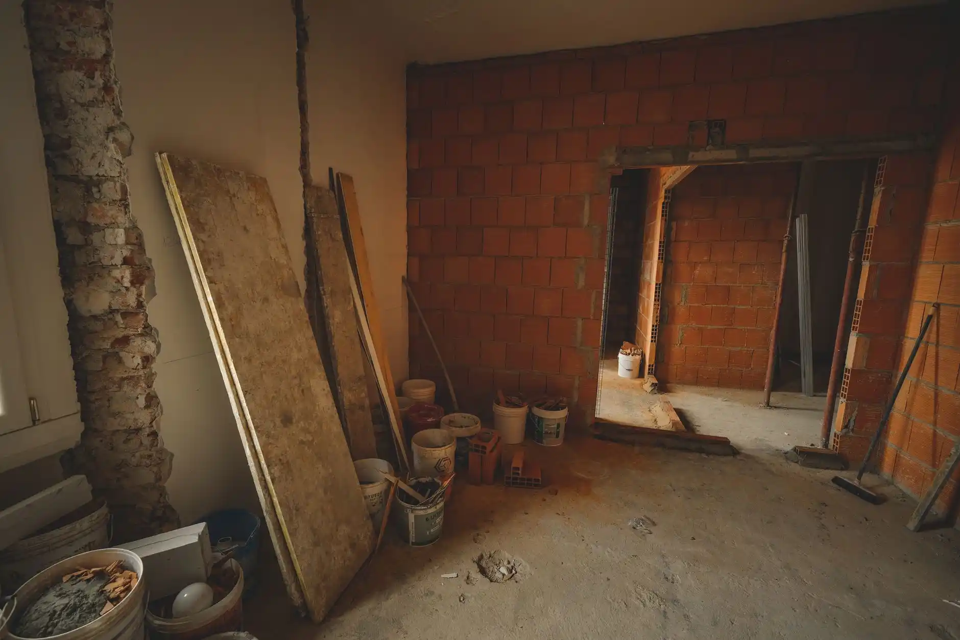 Editorial photograph illustrating "How Much Does It Cost to Remove a Load-Bearing Wall" in the context of removing a load-bearing wall, natural daylight, realistic setting, no t...