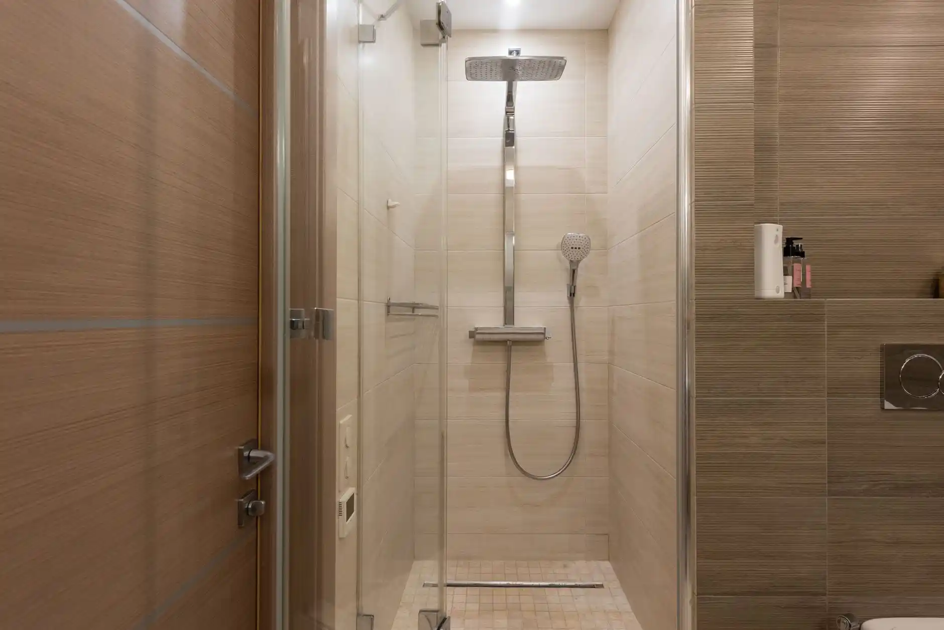 Editorial photograph illustrating "Should You Replace the Valve" in the context of tub to walk-in shower conversion cost, natural daylight, realistic setting, no text or logos i...