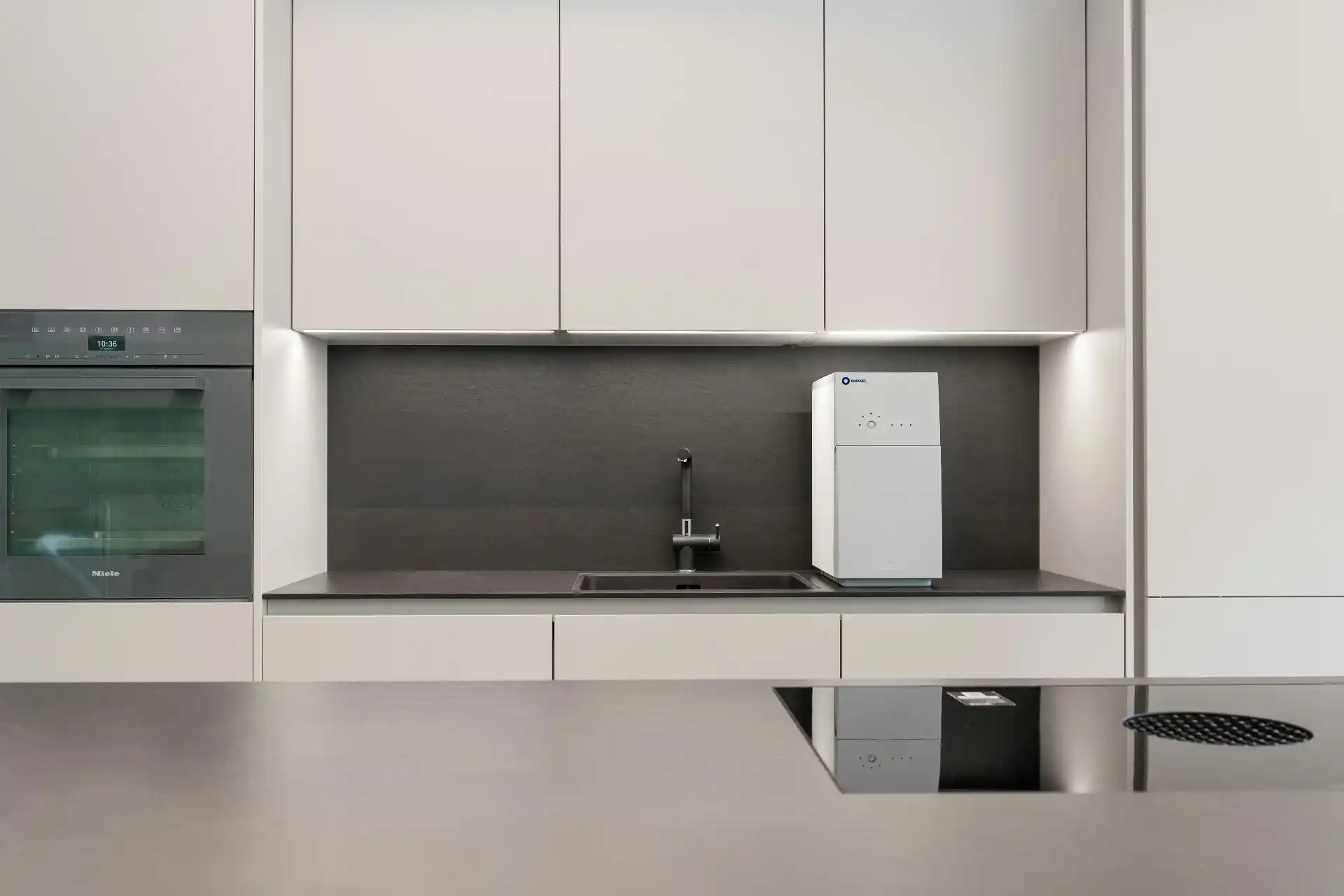 Editorial photograph illustrating "Cabinetry Can Be a Major Cost Driver" in the context of water damage restoration cost, natural daylight, realistic setting, no text or logos i...