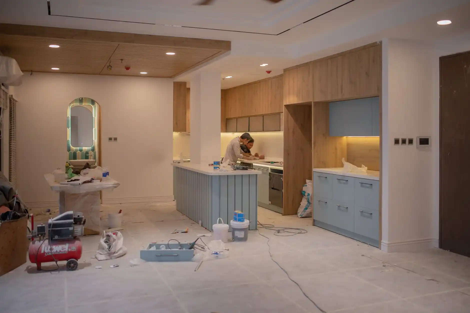 Editorial photograph illustrating "Kitchen Relocation vs Kitchen Reconfiguration" in the context of cost to move plumbing during remodel, natural daylight, realistic setting, no...