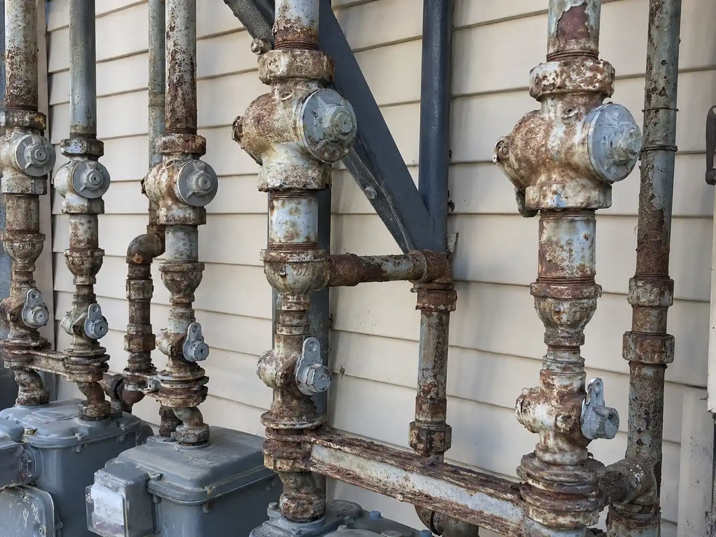 Editorial photograph illustrating "What About Old Drain Lines" in the context of galvanized plumbing replacement remodel, natural daylight, realistic setting, no text or logos i...