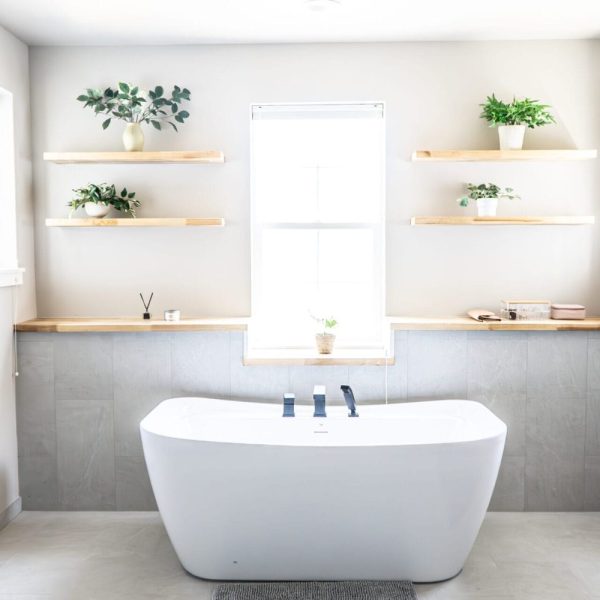 Contemporary bathroom remodel with freestanding tub and floating shelves