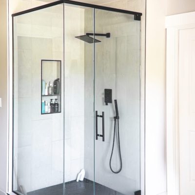 walk in shower with black fixtures