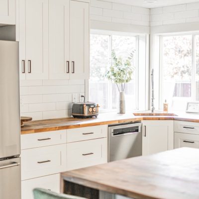 kitchen with white cabinets and stainless steel fridge