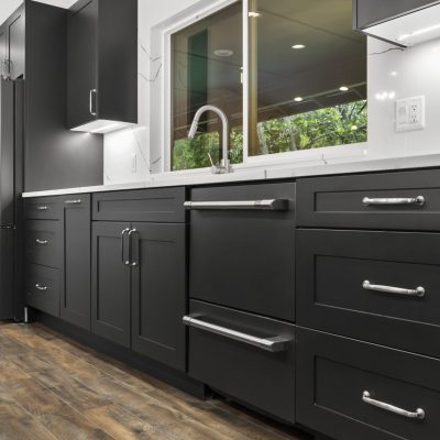 black kitchen cabinets and hardwood floors