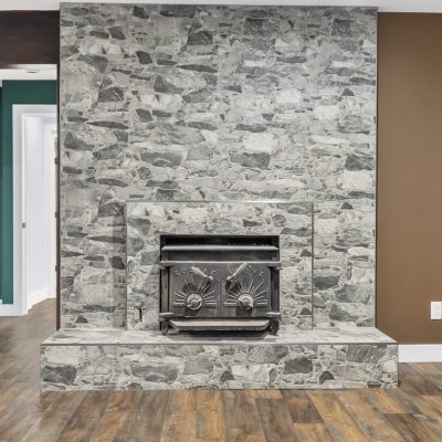 stone fireplace with hardwood floors