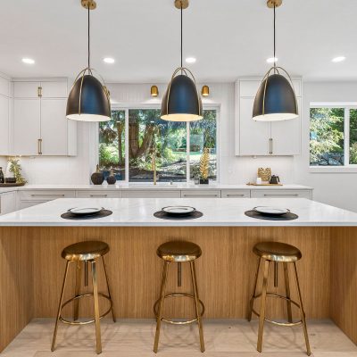 large kitchen island with hanging lamps and barstools