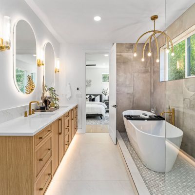 luxury bathroom with freestanding tub and brown cabinetry
