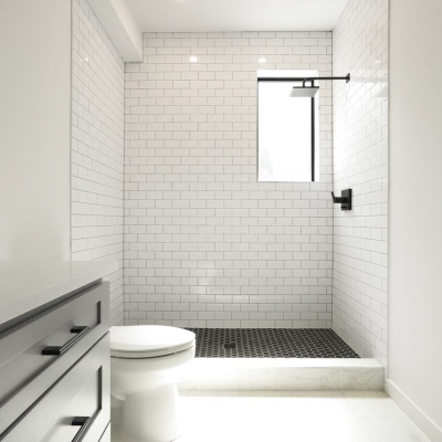 white bathroom with toilet and shower